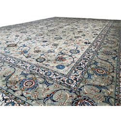 Persian Kashan pale sage green ground carpet, well-balanced design with interlacing branches interspersed with stylised flowerhead and leaf motifs, repeating scrolling border decorated with further stylised flowerheads within guard stripes