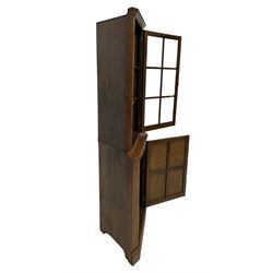 Albert Oldroyd - Oak corner display cabinet, fitted with bevelled glass door above panelled door, raised on plinth base