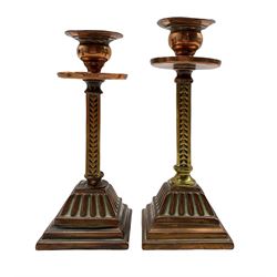 Pair of Arts and Crafts candlesticks with copper drip pans and square section stems on reeded square base, H17.5cm max