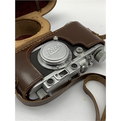 Leica IIIa camera body with 'Leitz Elmar f=5cm 1:3,5' lens, housed in a Leica case, with a Leica Guide 45th Edition