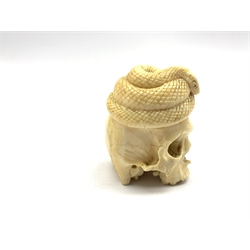 Late 19th century Japanese carved ivory okimono in the form of a skull beneath a coiled snake with a toad at the rear H5cm 