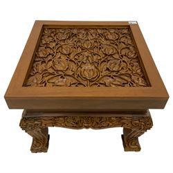 Carved hardwood coffee or lamp table, the square top carved with flower heads and foliage