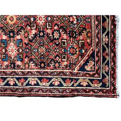 Persian Hamadan red ground runner, the field decorated with floral Herati motifs, trailing border decorated with small stylised flowerheads, framed within guard stripes