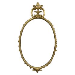 19th century giltwood and gesso wall mirror, the oval frame with c-scroll cartouche pediment decorated with foliage, foliate decorated frame terminating to c-scrolls