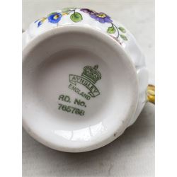 Aynsley Butterfly handle jug printed with a floral pattern rd. no. 785788 together with an Aynsley cup and saucer 