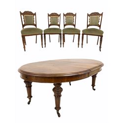 Victorian mahogany extending dining table, the oval top with one additional leaf raised on floral carved and fluted supports terminating in brass and ceramic cup castors (160cm x130cm, H75cm) together with set four Edwardian walnut dining chairs with floral carved crest rail over reeded frame, raised on turned supports terminating in castors (W48cm)