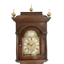 Thomas Hitchinson of Patterington - Early 18th-century oak cased 8-day longcase clock, with a caddy topped pediment and three ball and spire finials, break-arch hood door with pilasters and turned capitals, long trunk door with strap hinges and crossbanding, rectangular plinth with applied skirting, small10 x 10 x 14 inch break arch brass dial with cast spandrels and silvered boss engraved with makers name to the arch, silvered chapter ring with half hour markers, minute and quarter hour tracks, engraved and matted dial centre, matching steel hands, dial pinned directly to an unconventionally designed movement with ring turned steel arbors and recoil anchor escapement, count wheel striking movement, striking the hours on a cast bell.
With weights and pendulum.  
