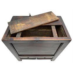 17th to 18th century Chinese fruitwood chest, possibly Gansu region, the lift-up lid with an iron strap set with two Chinese 'cash' coins, panelled front, sides and back, fitted with two small drawers, stile supports with shaped lower rail