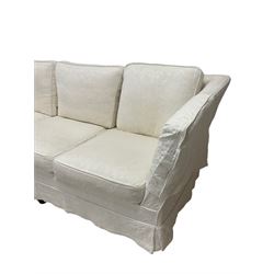 Three seat sofa, upholstered in cream cotton with floral and foliate design, raised on turned bun feet