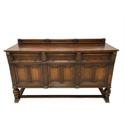 Early 20th century oak sideboard, three drawers with blind tracery work decoration over three panelled cupboards, turned supports connected by stretcher