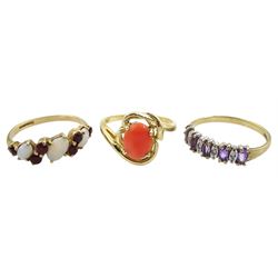 Gold single stone coral ring, stamped 14K, gold amethyst and diamond ring and an opal and garnet, both hallmarked 9ct