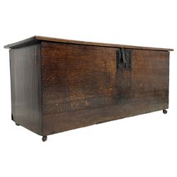 18th century oak coffer or chest, rectangular hinged two plank lid with moulded edge, fitted with wrought metal lock and clasp, on castors