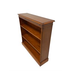 Figured yew open bookcase, the rectangular top with moulded edge over frieze with inlay over two adjustable shelves, raised on a plinth base W92cm, H92cm, D26cm