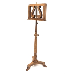 Quality mahogany duet easel music stand of lyre form, raised on reeded and leaf carved column over platform base with paw feet, H148cm