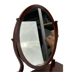 Regency Revival mahogany dressing table mirror, oval swing mirror with scrolled uprights, the concave base fitted with two drawers, raised on ogee bracket feet, decorated with satinwood stringing
Provenance: From the Estate of the late Dowager Lady St Oswald
