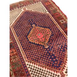 Persian Hamadan rug, extended lozenge field decorated with small stylised motifs and central medallion, floral design border