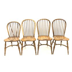 Matched set four 20th century elm Windsor dining chairs, hoop and spindle back over saddle seat, raised on turned supports united by crinoline stretcher 