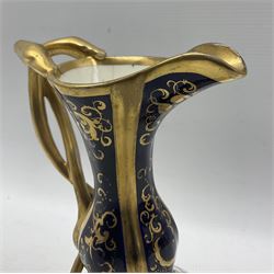 Late 18th century Chamberlains Worcester ewer, of squat form with slender neck and entwined serpent handle, the body with two reserves painted with floral sprays, on a cobalt blue and gilt low relief ground, with puce painted marks beaneath, H21cm 