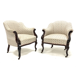 Pair of late Victorian walnut upholstered armchairs, with scrolled arm terminals, raised on floral carved cabriole supports terminating in castors, 
