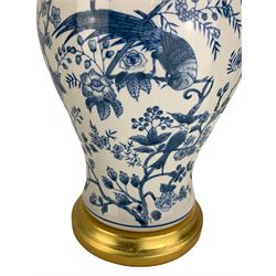 Pair of blue and white table lamps, each of inverted baluster form, decorated with exotic birds, raised upon circular gilt bases, H39cm excluding fitting