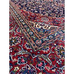 Fine hand Knotted Persian Kashan red and blue ground carpet, the busy central field decorated with interlaced foliate 400cm x 295cm