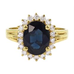 18ct gold oval cut sapphire and round brilliant cut diamond cluster ring, stamped 750
