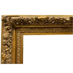 19th century ornate heavy gilt stepped frame, decorated with pronounced foliate patterns and flowerheads, aperture 24cm x 40cm