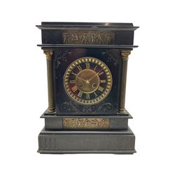 A Belgium slate mantle clock with a French striking movement c1880, flat top pediment and frieze beneath with two matching panels of brass repoussé work depicting scenes from Greek antiquity, with incised decoration and flanking reeded brass pillars with Corinthian capitals, two-part Belgium slate dial with a gilt centre, gold incised roman numerals and brass fleur de Lis hands, cast brass bezel with a flat bevelled glass and egg and dart slip, with an eight day movement striking the hours and half hours on a coiled gong. With pendulum.

