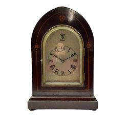 An Edwardian mahogany mantle clock with contrasting satinwood inlay c1905, in a lancet topped case on a projecting plinth with bun feet, silvered sheet dial with etched engraving, Roman numerals and minute track, subsidiary silent/chime dial and steel spade hands, with an arch topped glazed door and silvered slip, two train Westminster chiming movement, chiming on four gong rods, eight -day German movement manufactured by the Hamburg American Clock Company or HAC. HAC was formed in Germany in 1873 by Paul Landenberger . With pendulum.  



