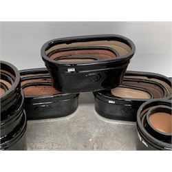  Three sets of three black glazed terracotta plant pots (W57cm) and approx 9 other black glazed cylindrical plant pots, (D33cm)   