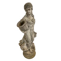 Composite stone garden figure modelled as an Italian maiden carrying baskets, on naturalist base with wild flowers