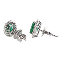 Pair of 18ct white gold oval emerald and round brilliant cut diamond cluster stud earrings, stamped, total emerald weight 2.85 carat, total diamond weight 0.78 carat , with World Gemological Institute Report