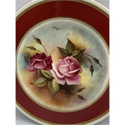 Cabinet plate painted with fruit by James Skerrett with a dark blue and gilt border D28cm, another by the same artist painted with roses with a red border D27cm and another painted with fruit by Leighton Maybury D23cm.  Skerrett and Maybury were previously Royal Worcester artists (3)