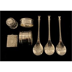 Three John Pinches silver Christmas spoons, silver vesta case Chester 1902, two silver serviette rings and a small glass toilet bottle with silver cover 5.6oz