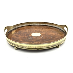  Early 20th Century oak oval tea tray with pierced plated two handled gallery and compressed bun feet W52cm  