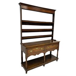Georgian oak dresser, projecting cornice over plain frieze and three heights plate rack, the lower sections with rectangular top over two cockbeaded drawers and shaped aprons, turned supports joined by undertier, with shaped brass handle plates and escutcheons