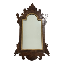20th century Georgian style mahogany mirror, shaped fret work frame, stepped arched aperture with moulded gilt slip and cross grain banding, 71cm x 40cm