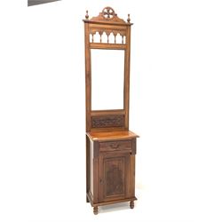 20th century walnut hall stand, the raised back with urn finials, spindle gallery and bevelled mirror, over drawer and panelled cupboard with incised floral decoration, raised on turned front supports W50cm, H214cm, D36cm