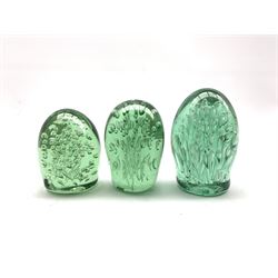 Victorian green glass dump paperweight of domed form with control bubble decoration, H12.5cm together with two others (3)