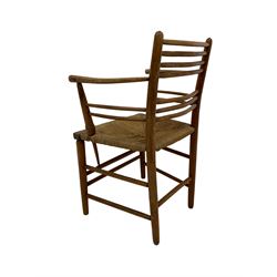 19th century elm and beech Sussex elbow chair, the ladder back over rush seat with turned arm supports, raised on tapered supports united by stretchers