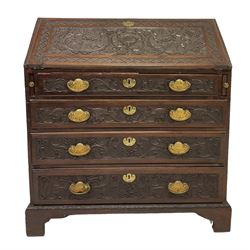 20th century mahogany bureau, the fall front enclosing fitted interior over four short drawers, all profusely carved, raised on bracket supports 