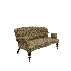 19th century walnut and metal framed settee, upholstered in buttoned foliate patterned fabric, turned front supports with brass and ceramic castors