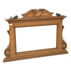 Edwardian oak overmantle mirror, the swan neck pediment centred by shield, over rectangular plate, the frame decorated with carved 'C' scroll and acanthus leaf 110cm x 80cm