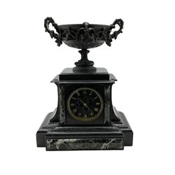 French - late 19th century 8-day Belgium slate mantle clock with a  break front case and variegated marble panels, flat top pediment surmounted by a shallow oval bowl with garland swags, conforming slate and marble dial with incised gold Roman numerals and brass moon hands, rack striking twin train Parisian movement striking the hours on a bell. With pendulum.
