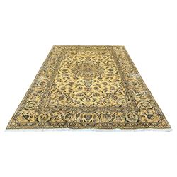 Persian Kashan golden ivory ground rug, decorated all over with interlaced foliate and stylised motifs, central rosette medallion, scrolled border with repeating motifs