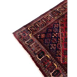 Iranian Joshagan crimson ground carpet, the central indigo lozenge containing further traditional geometric motifs, with matching spandrels, the field with all-over stylised plant decoration, the guarded border with alternating tree of life and other foliate motifs