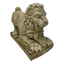 Pair of composite garden ornaments in the form of Dog of Foo, the lion in a crouched pose with a ram mask below