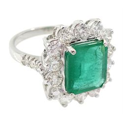 18ct white gold emerald and round brilliant cut diamond cluster ring, with diamond set shoulders, stamped 18K, emerald 3.40 carat, total dimaond weight 1.70 caratwith World Gemological Institute Report