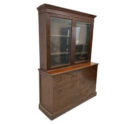 19th century mahogany display cabinet, the projecting cornice over two glazed doors enclosing four adjustable shelves, over four short and one long drawer, raised on a plinth base 