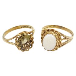 Gold single stone opal ring and a gold single stone smoky quartz ring, both 9ct